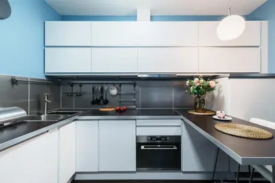 a kitchen with white cabinets and a black counter top at Apartament Old Town Comfort Balkon & Parking in Kraków