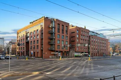 an empty street in front of two brick buildings at Apartament Old Town Comfort Balkon & Parking in Kraków