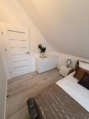 a stairway with white walls and a white stair case at Glamoon Mountain Apartment - Prywatne spa w sercu Podhala in Nowy Targ