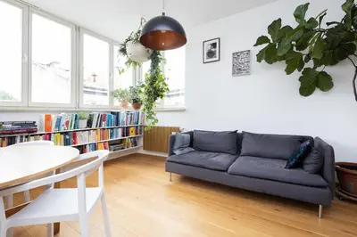 a living room with a couch and a table at Sunny 2B apartment in City Centre in Kraków