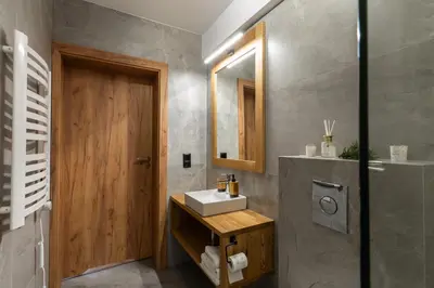 a bathroom with a sink and a mirror at Olesiówka in Nowy Targ