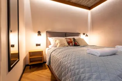 a bedroom with a bed with a blue comforter at Olesiówka in Nowy Targ