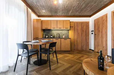 a kitchen and dining room with a table and chairs at Olesiówka in Nowy Targ