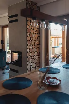 a dining room with a table with blue plates and a fireplace at Muciówka in Jurków