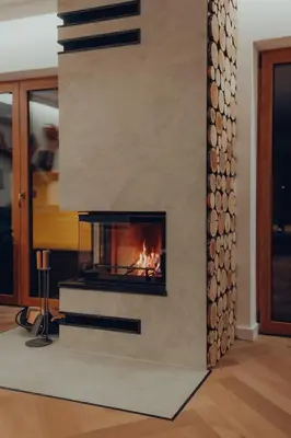 a fireplace in a living room with a fire place at Muciówka in Jurków
