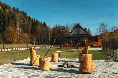 a playground with a swing in a park at Muciówka in Jurków