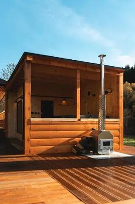 a building on a deck with a tv on it at Muciówka in Jurków