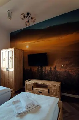 a bedroom with a painting on the wall at Muciówka in Jurków