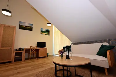 a living room with a couch and a table at Stay at Royal Kraków Golf