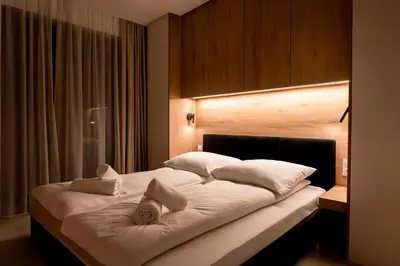 a bedroom with a large bed with white pillows at Apartament Zakrzówek - Chilloway in Kraków