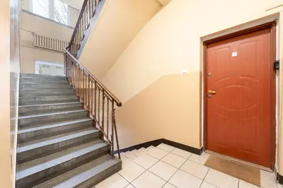 a staircase in a house with a red door at Urzędnicza Homely Apartment by BookingHost in Kraków