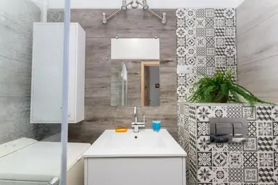 a bathroom with a sink and a mirror at Urzędnicza Homely Apartment by BookingHost in Kraków