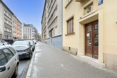 a street with cars parked next to a building at Urzędnicza Homely Apartment by BookingHost in Kraków