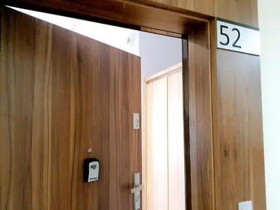 a bathroom door with a sign on the wall at Modern studio on Wrocławska with balcony in Kraków