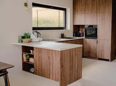 a kitchen with wooden cabinets and a counter top at Vidok House