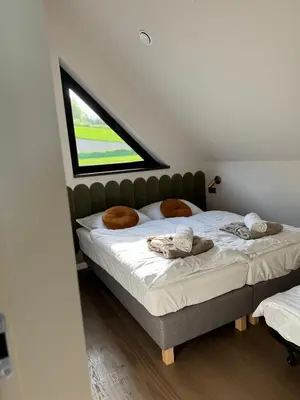 a bedroom with a large bed with a window at Vidok House