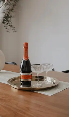 a bottle of wine and two glasses on a tray at Vidok House