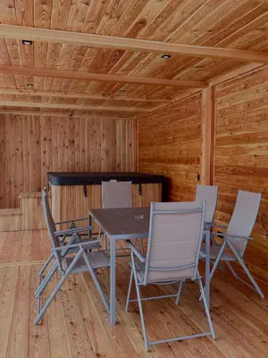 a dining room with a table and chairs in a cabin at Leśna Przystań in Sidzina