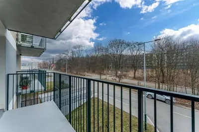 a balcony with a view of a street at Czerwone Maki Deluxe Apartment by BookingHost in Kraków