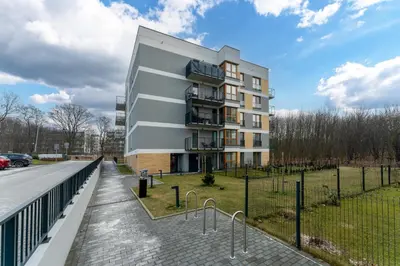 a building with balconies on the side of a street at Czerwone Maki Deluxe Apartment by BookingHost in Kraków