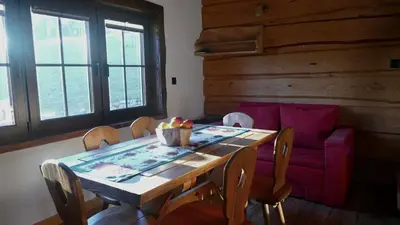 a living room with a staircase in a log cabin at Chatka Pod Dębem in Rozdziele