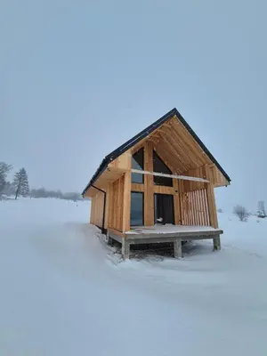 a small wooden building in the snow at Stodoła na Hamajdówce in Zubrzyca Górna