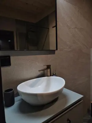 a white bowl sink on a counter in a bathroom at Stodoła na Hamajdówce in Zubrzyca Górna