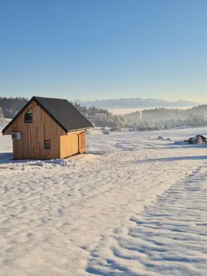 a small house in the snow with a footprints at Stodoła na Hamajdówce in Zubrzyca Górna
