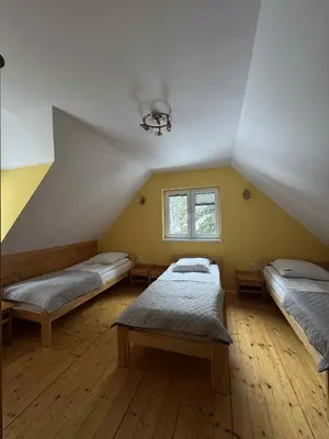 a bedroom with a bed and a table in it at Ośrodek Nad Potokiem in Poręba Wielka