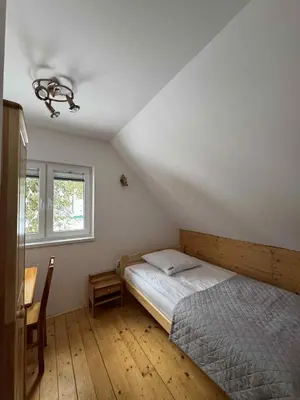 a wooden staircase with a bench in a room at Ośrodek Nad Potokiem in Poręba Wielka