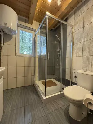 a bathroom with a sink and a shower and a mirror at Ośrodek Nad Potokiem in Poręba Wielka