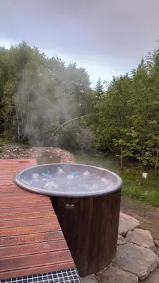 a hot tub sitting on top of a wooden deck at MC Na Leśnej Polanie in Szczawa