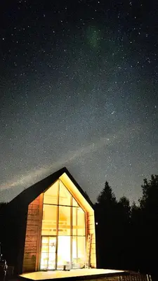 a cabin with a window in the night sky at MC Na Leśnej Polanie in Szczawa