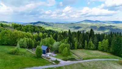 an aerial view of a house on a hill with a road at MC Na Leśnej Polanie in Szczawa