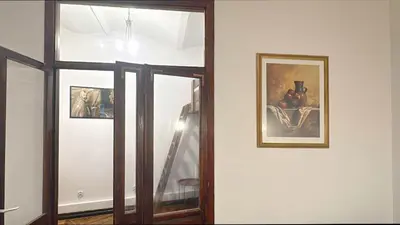 a room with two pictures on the wall and a mirror at Tawerna Krakowska in Kraków