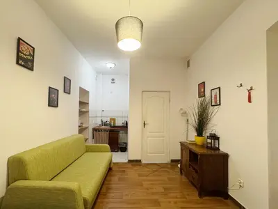 a living room with a couch and a table at Asnyka comfy in Kraków