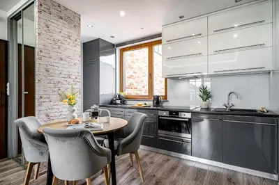 a kitchen with a table and chairs in a kitchen at Lubicz Boutique Apartment - Old Town Area in Kraków
