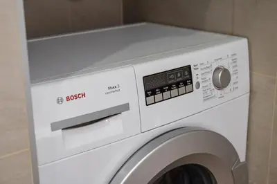 a white washer and dryer in a bathroom at Lubicz Boutique Apartment - Old Town Area in Kraków