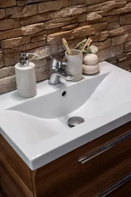 a bathroom sink with two mugs on top of it at Lubicz Boutique Apartment - Old Town Area in Kraków