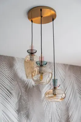 a chandelier hanging from a ceiling in a room at Lubicz Boutique Apartment - Old Town Area in Kraków