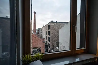 an open window with a view of a building at Lubicz Boutique Apartment - Old Town Area in Kraków