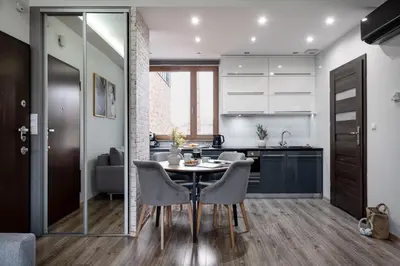 a kitchen and dining room with a table and chairs at Lubicz Boutique Apartment - Old Town Area in Kraków
