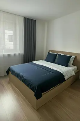 a bedroom with a large bed with blue pillows at Comfortable room near old town Krakow in Kraków