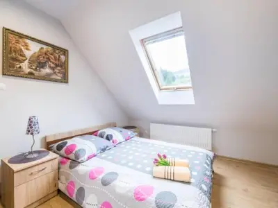 a bedroom with a bed and a window at Pod Stokiem in Lubomierz