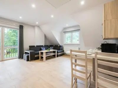 a living room with a couch and a table at Pod Stokiem in Lubomierz