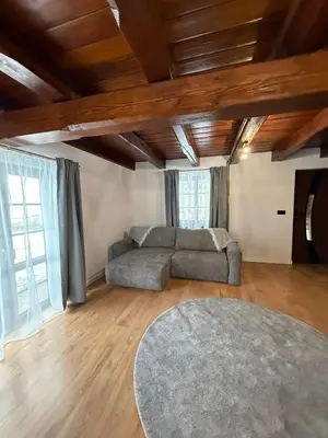 a living room with a couch and a rug at Domek Ostoja Zator Graboszyce in Graboszyce