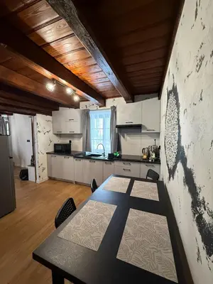 a large kitchen with a table in a room at Domek Ostoja Zator Graboszyce in Graboszyce