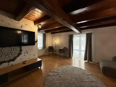 a living room with a television and a couch at Domek Ostoja Zator Graboszyce in Graboszyce