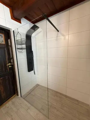 a walk in shower with a glass wall at Domek Ostoja Zator Graboszyce in Graboszyce