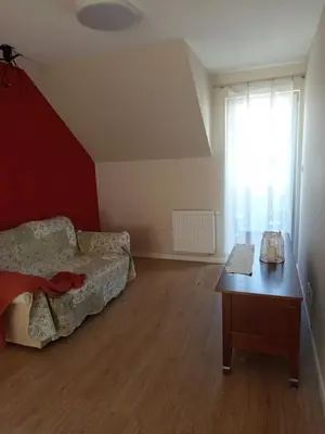 a bedroom with a bed and a desk and a window at Rainbow Hill in Giebułtów